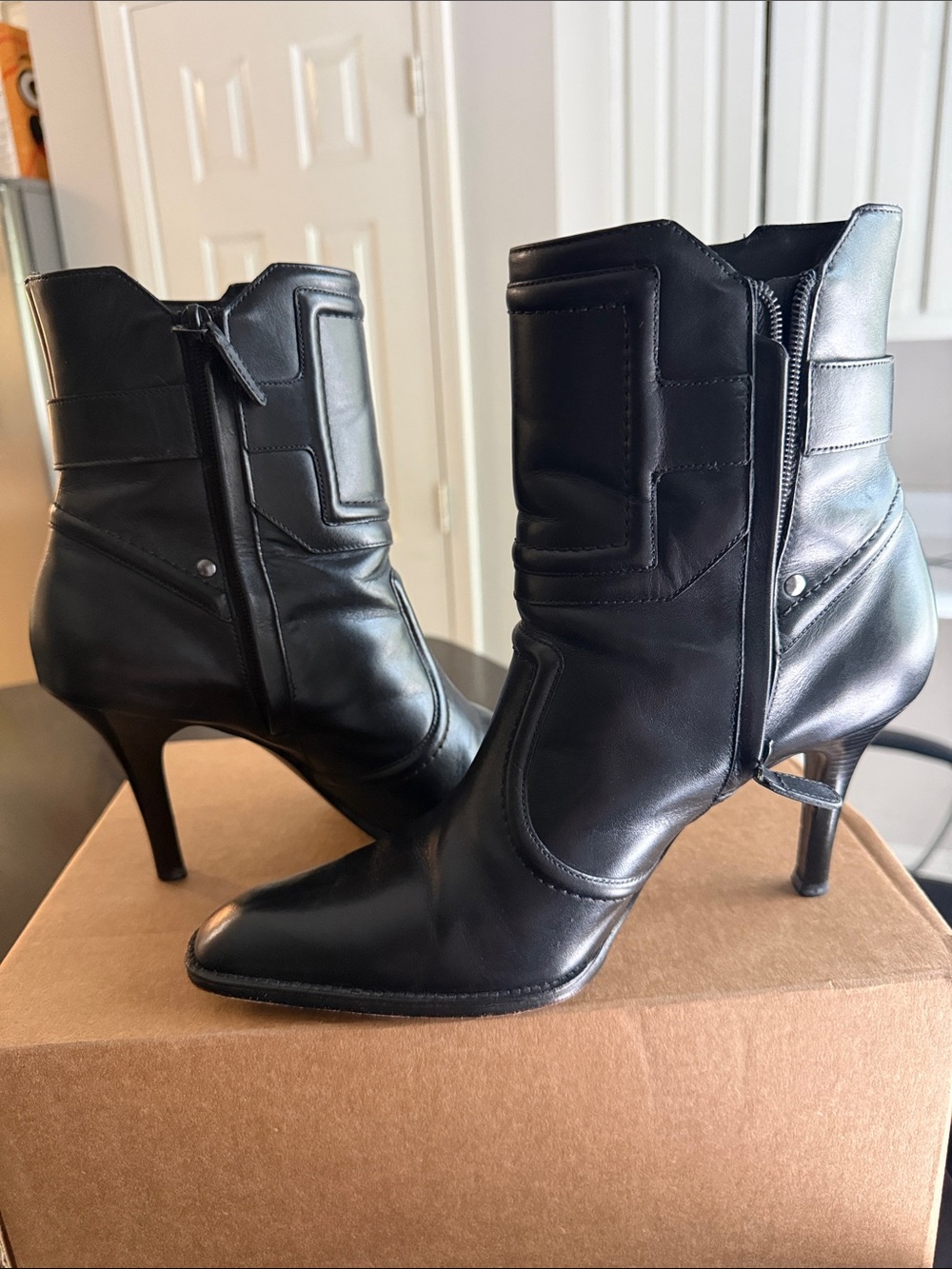 Cole Haan Yelena Short Boots Feature Black Brazilian Leather W/ A Buckle Strap